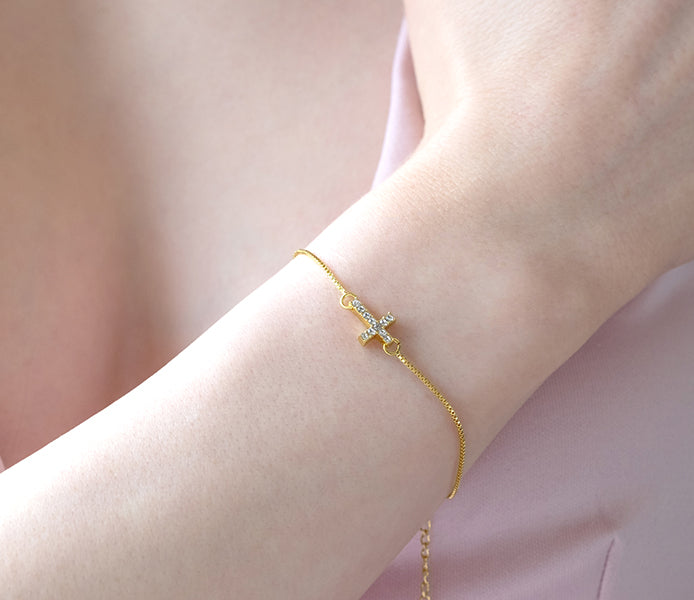 Cross bracelet with crystals in yellow gold platin