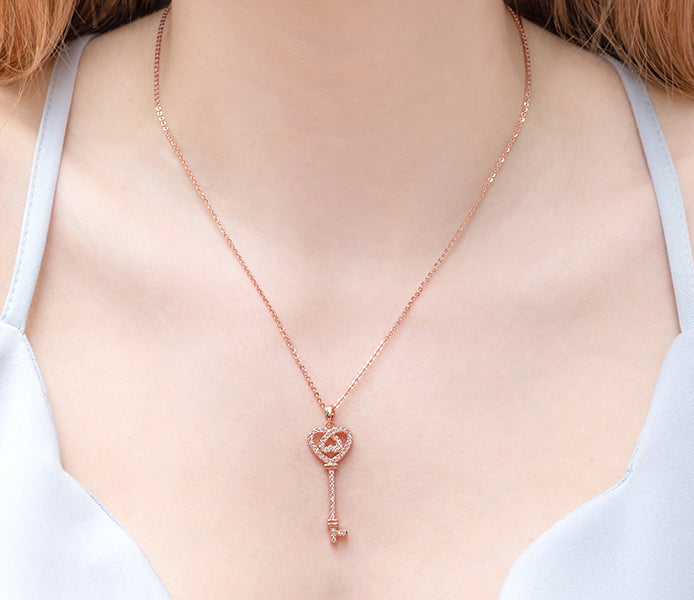 Ornate key pendant in rose gold plating